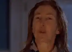 Woman rolls eyes back and sticks out tongue