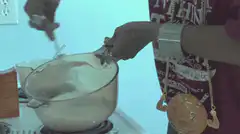 Person stirring pot on stove