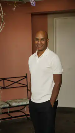 Smiling bald man in white polo shirt