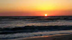 Sunset over the ocean waves