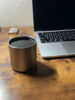 Coffee cup next to laptop