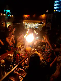 Bartender flambe cocktail at bar