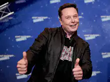 Elon Musk thumbs up then shrug