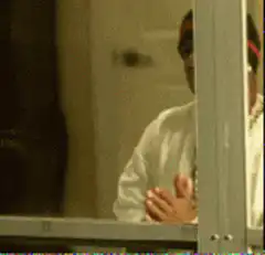 Man in beanie praying with hands together