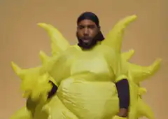Man in inflatable sun costume dancing