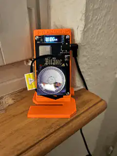 Bitcoin mining device on wooden shelf
