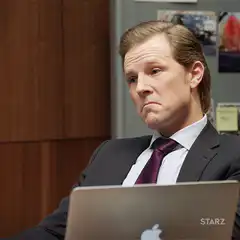 Man in suit looking unimpressed