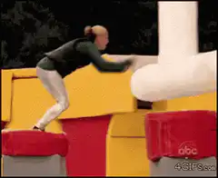 woman falls off giant lego obstacle
