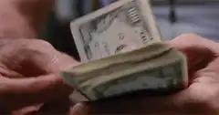 Hands counting a stack of hundred dollar bills
