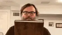 Jack Black reads a glowing book