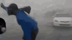 Man dancing in heavy rain