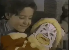 Boy holding a clown doll