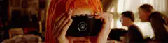 Woman holding Chanel camera to eye