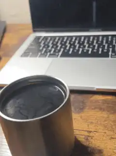 Coffee cup in front of laptop