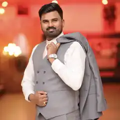 Man in grey suit holding jacket