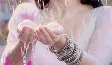 Woman splashing water on her face