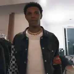 Man dancing and pointing at his chain