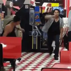 Man throws another man onto a diner booth