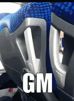 Boy peeking over bus seat with GM text