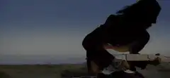 Blonde man in car with guitarist on roof