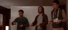 Three guys dancing in a room