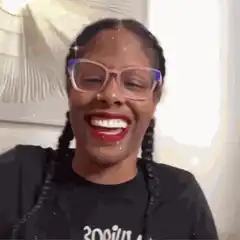 Woman laughing and waving hand