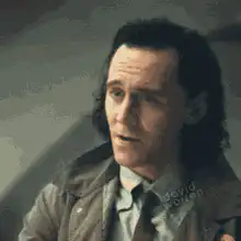 Tom Hiddleston as Loki smirking