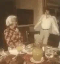 man throws pillow at woman