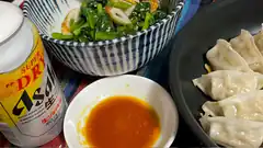 Asahi beer with dumplings and greens