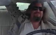 The Dude driving and smiling