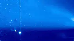 Blue sky with falling light streaks