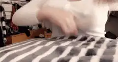 person rubbing hands on striped blanket