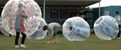 People in bubble soccer balls