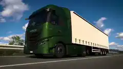 Green Iveco truck driving on highway