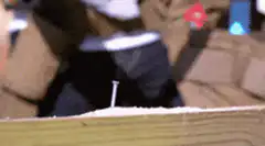 Hammer hitting nail into wood