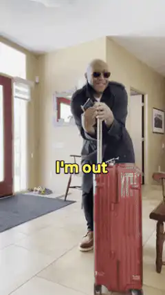 Man leaving with suitcase saying I'm out
