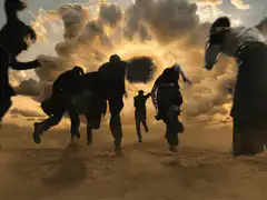 Blindfolded man running with group