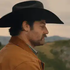 Man in cowboy hat tips hat