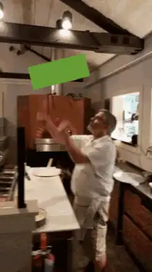 Man in kitchen with green rectangle