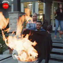 Man blows out fire with cape