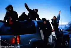 people dancing on a car