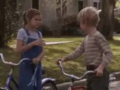Kids on bikes make a fist bump and shake hands