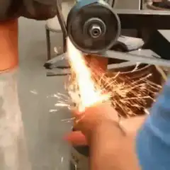 Hand held against angle grinder sparks