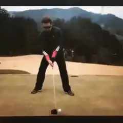 man swings golf club and falls