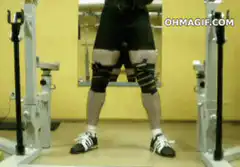Man does handstand under squat rack