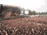 Fireworks explode on stage at outdoor concert