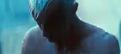 Blonde man in rain looking down