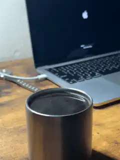 steaming metal cup on desk