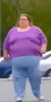 Woman in purple shirt walking