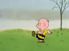 Lucy kicks Charlie Brown in the football